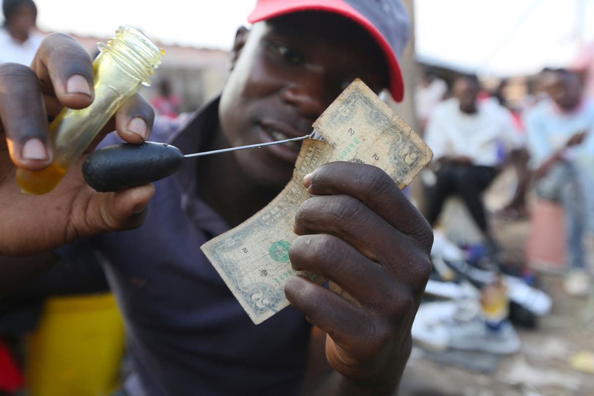 Zimbabweans mend shabby dollar notes amid economic crisis