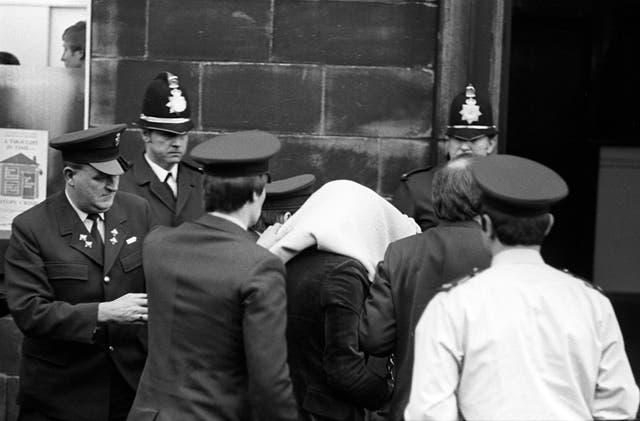 <p>Peter Sutcliffe, under a blanket, arriving at Dewsbury Magistrates’ Court, in February 1981</p>