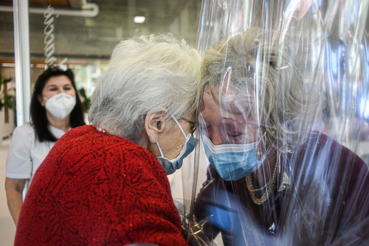 Italian care home installs plastic curtains for residents to cuddle loved ones