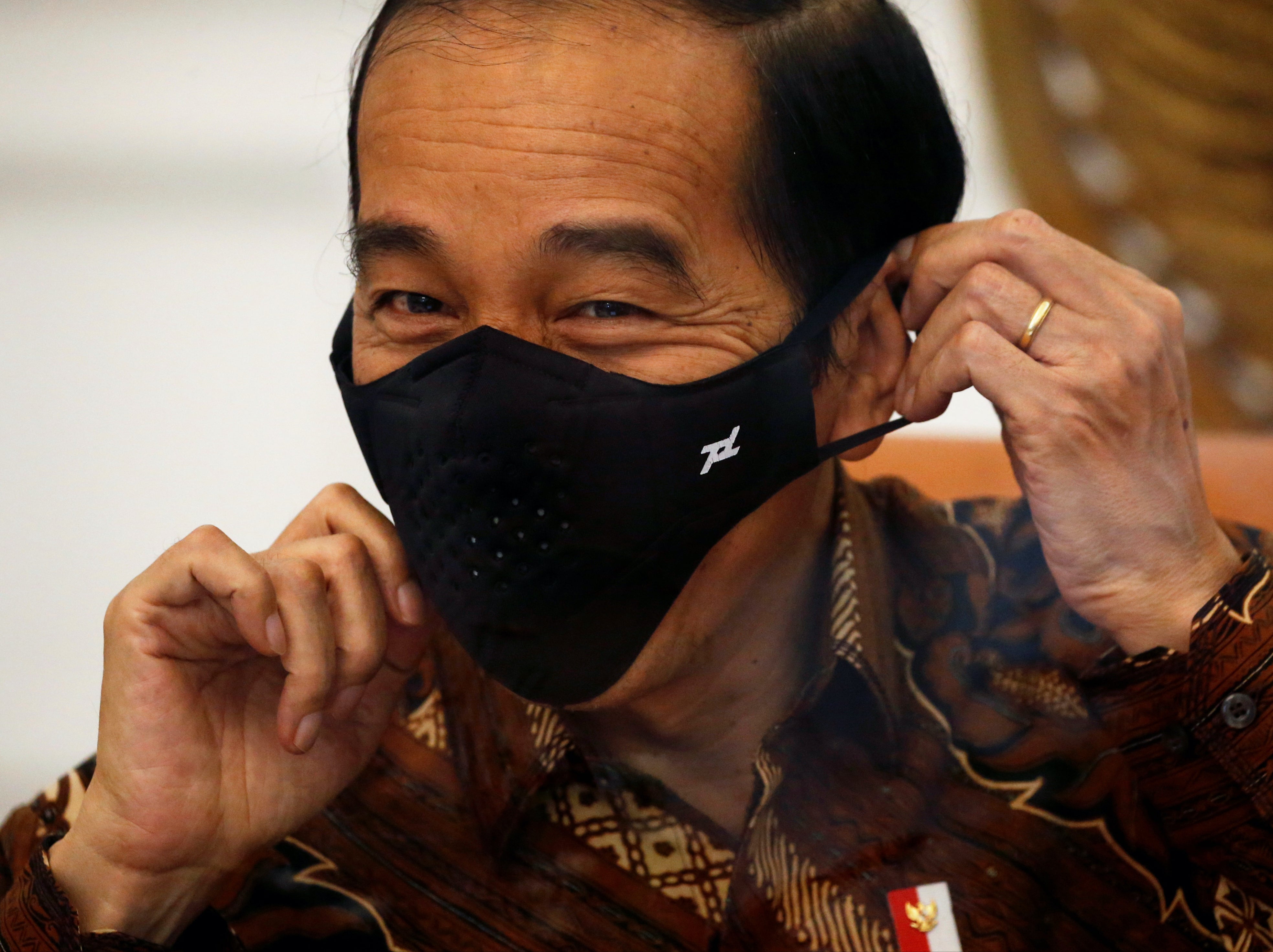 Joko Widodo wears a mask during an interview at the Presidential Palace in Jakarta