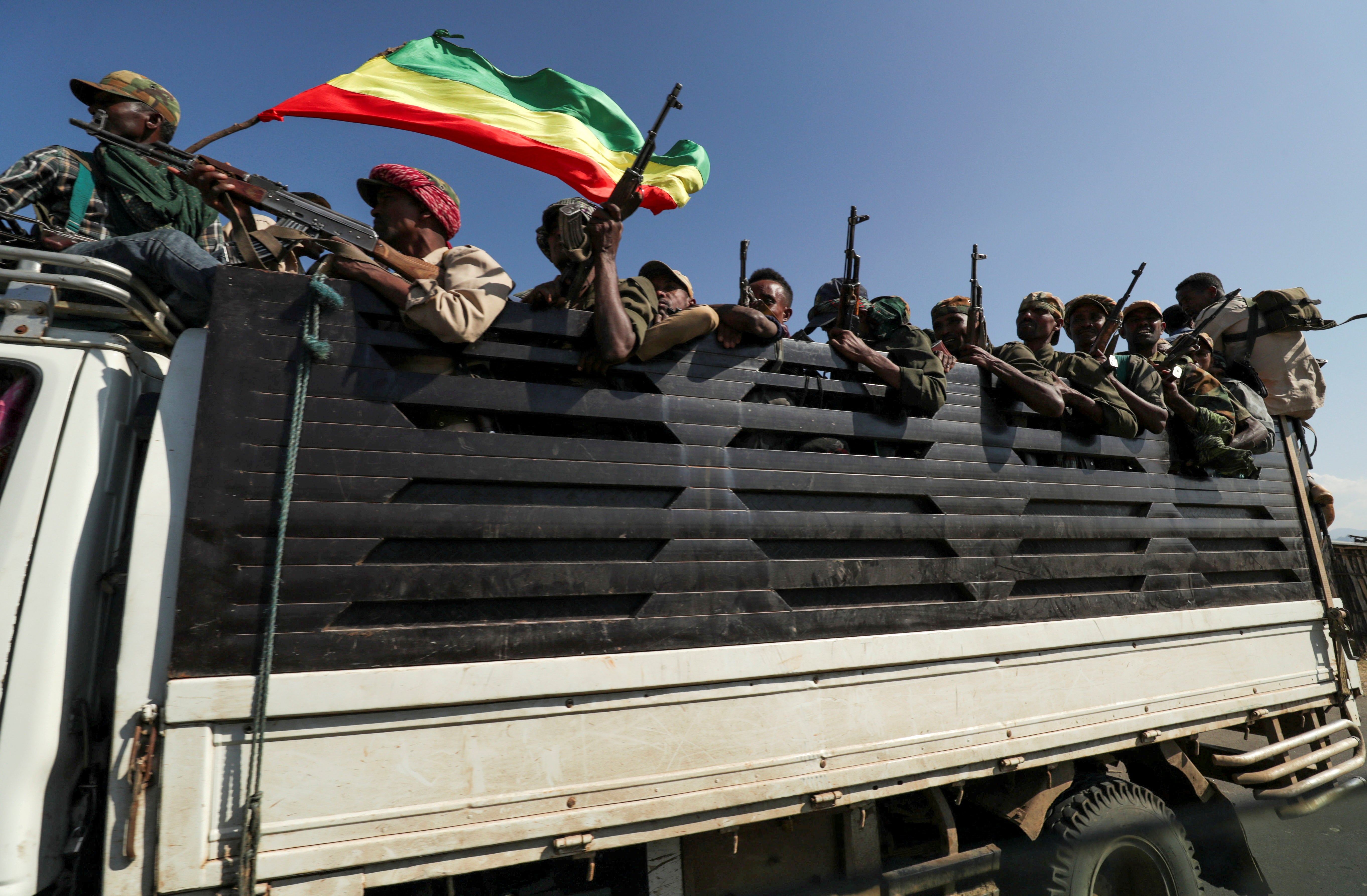 Members of Amhara region militias ride on their truck as they head to face the Tigray People’s Liberation Front on 9 November
