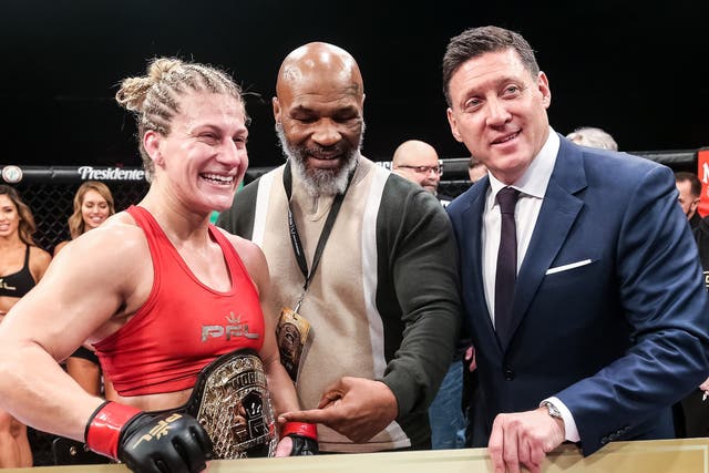 <p>Mike Tyson (centre) with PFL women’s lightweight champion Kayla Harrison and CEO Peter Murray</p>