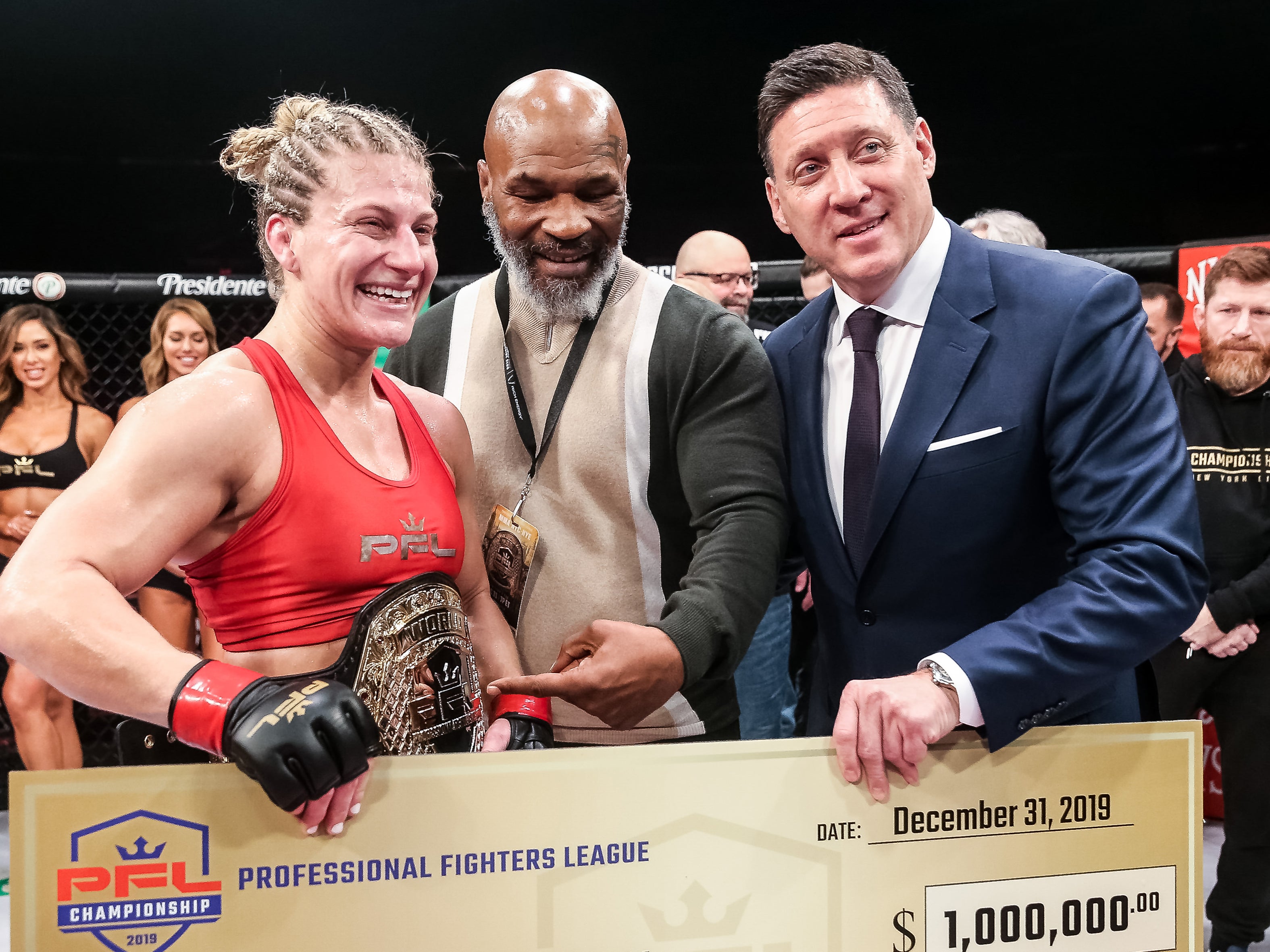 PFL women’s lightweight champion Kayla Harrison with Mike Tyson and CEO Peter Murray