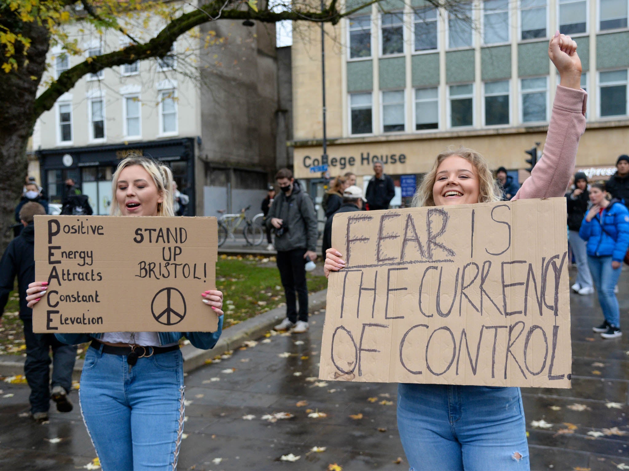 Protesters holding placards during the anti-lockdown protest on 14 November in Bristol