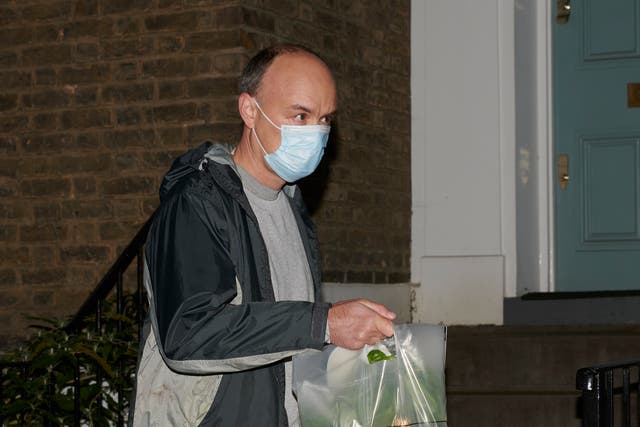 London, UK. 13th November  2020.   Dominic Cummings returns to his house with bottles of wine and champagne.