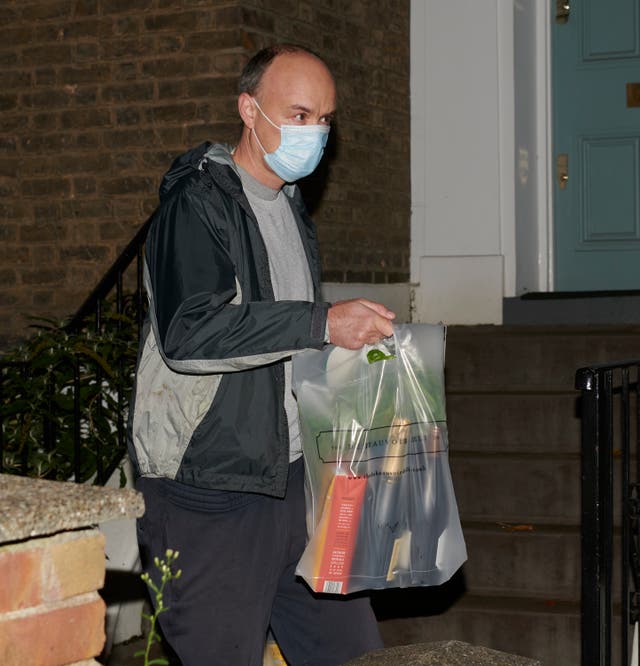 London, UK. 13th November  2020.   Dominic Cummings returns to his house with bottles of wine and champagne.