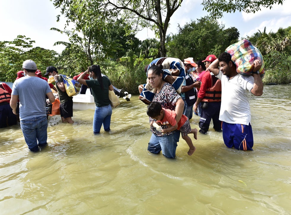 <p>Inhabitants walk through an avenue flooded by heavy rains in Macuspana, Mexico (EPA/Jaime Avalos)</p>