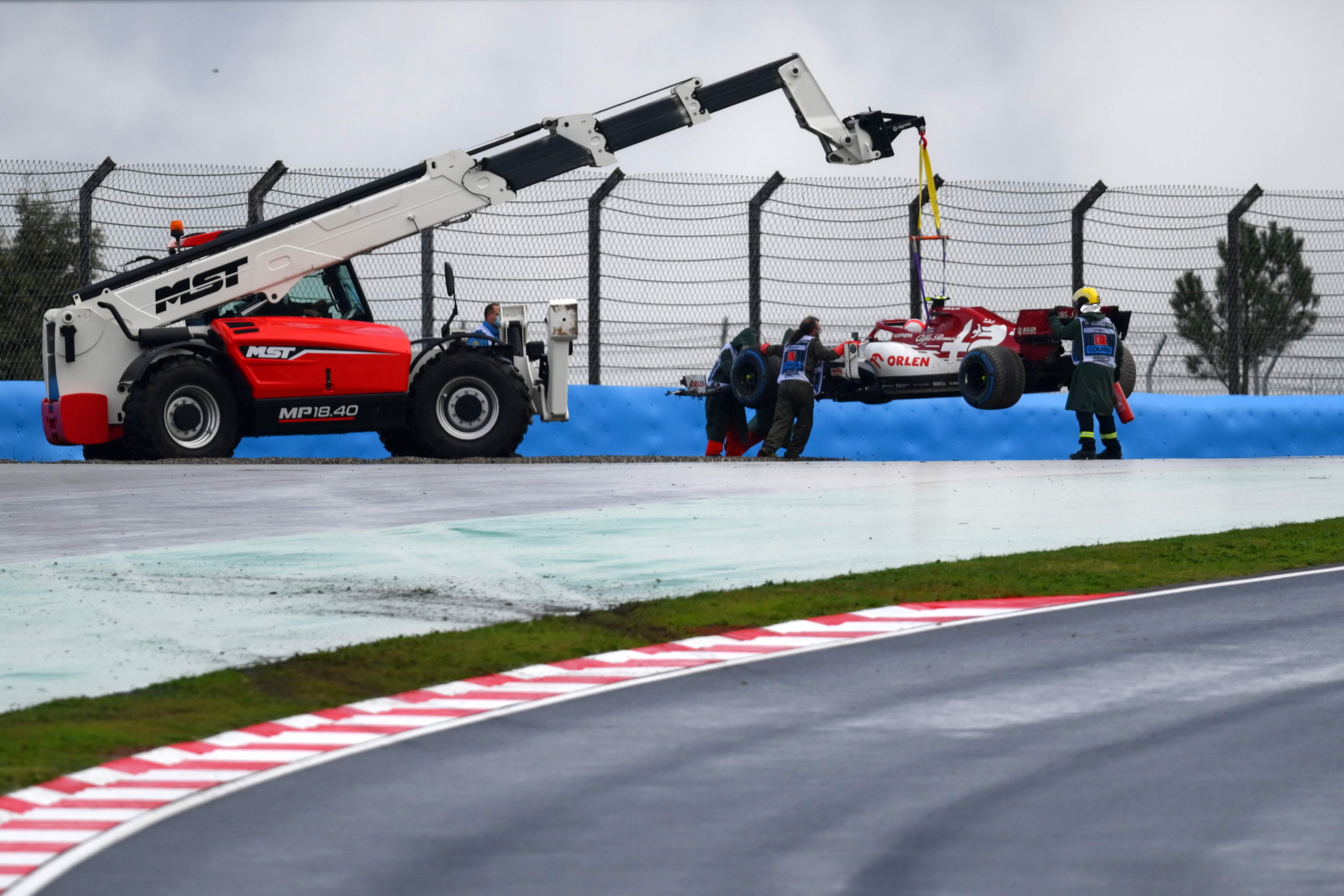 Antonio Giovinazzi is winched out of the gravel after crashing on his way to the grid