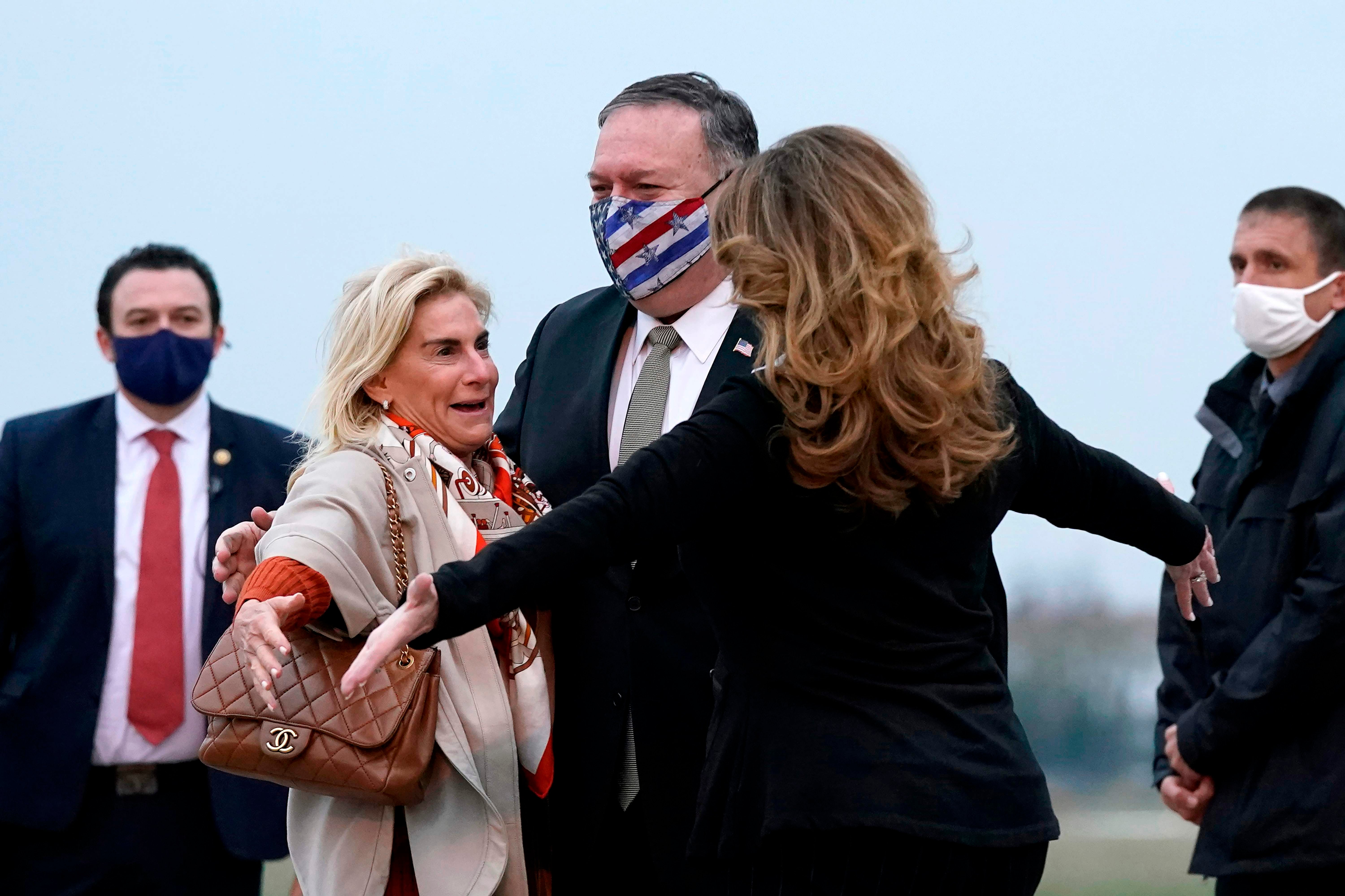 Secretary of state Mike Pompeo and his wife Susan (right) embrace US ambassador to France Jamie McCourt (left) after stepping off a plane at Paris Le Bourget airport