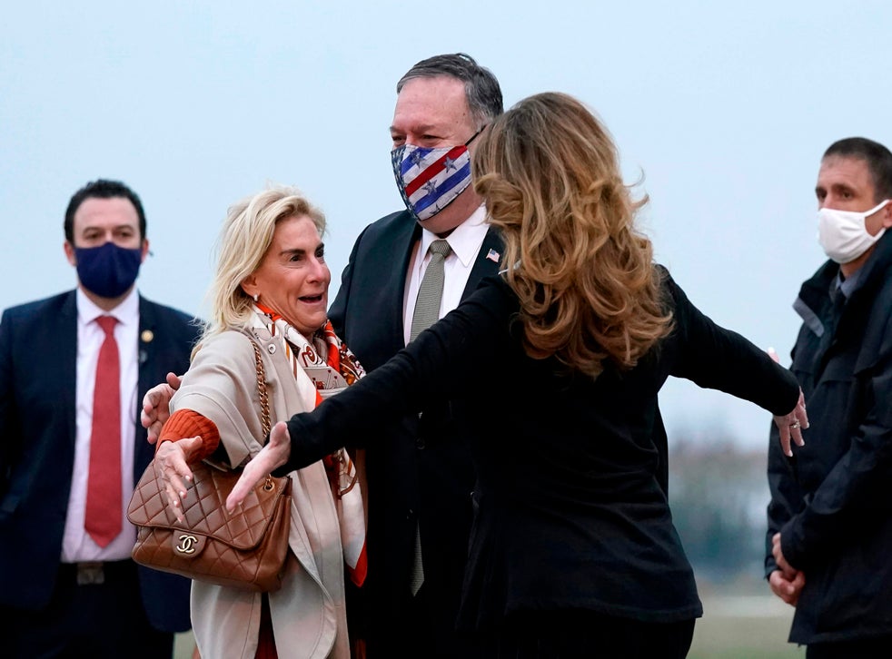 Secretary of State Mike Pompeo (C) and his wife Susan (R) embrace US Ambassador to France Jamie McCourt (L) after stepping off a plane at Paris Le Bourget Airport