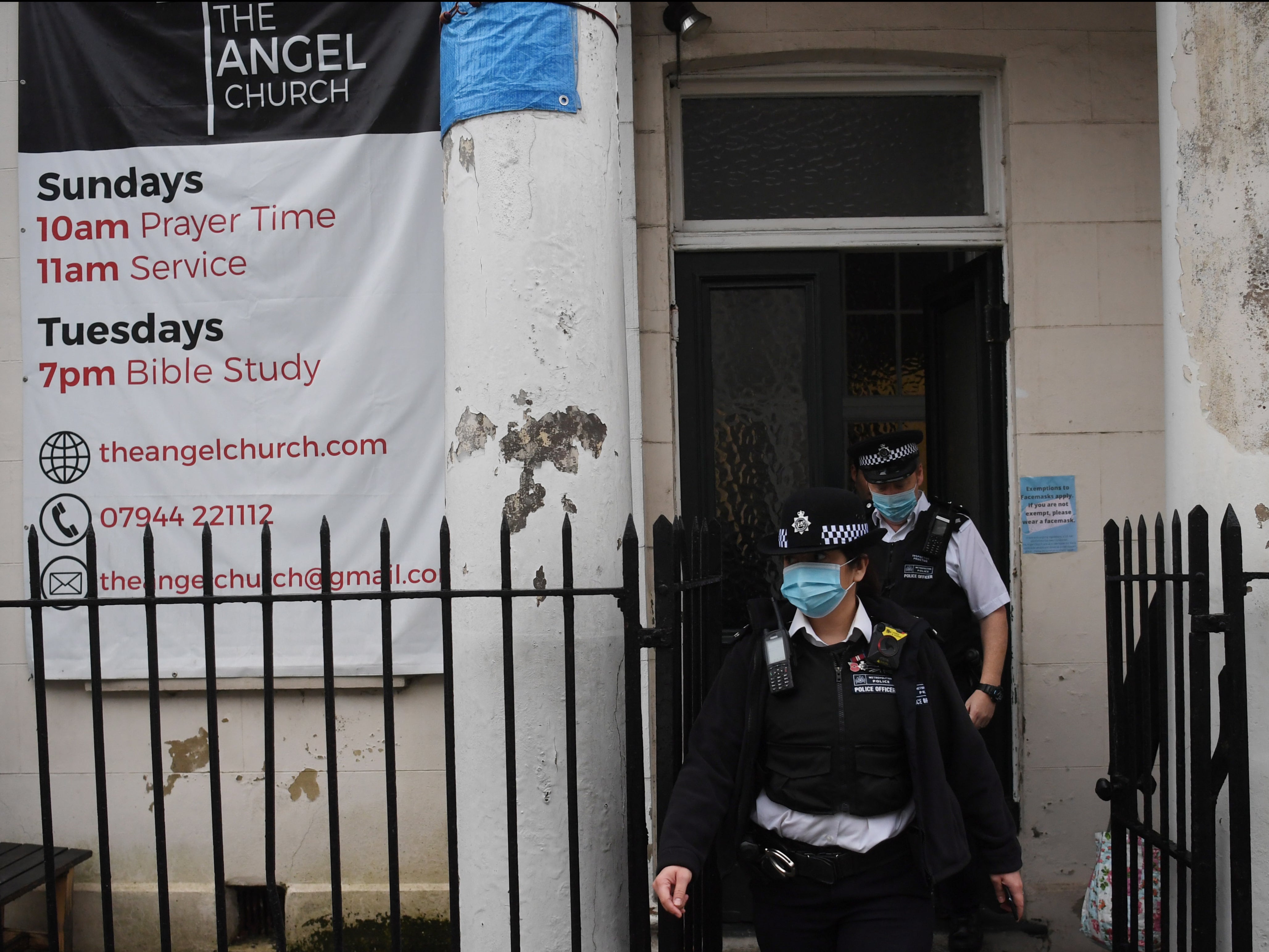 Police leave the Angel Church in north London. Pastor Regan King said he disagreed with the enforcement of restrictions on religious gatherings