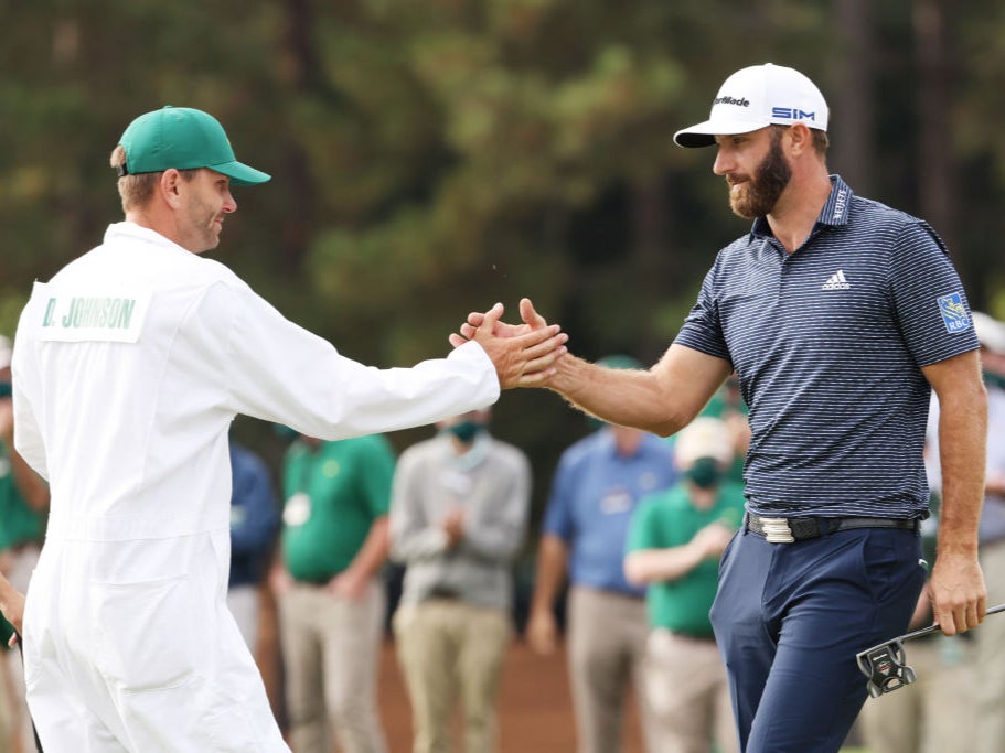 Dustin Johnson celebrates with his brother, Austin, who is also his caddie