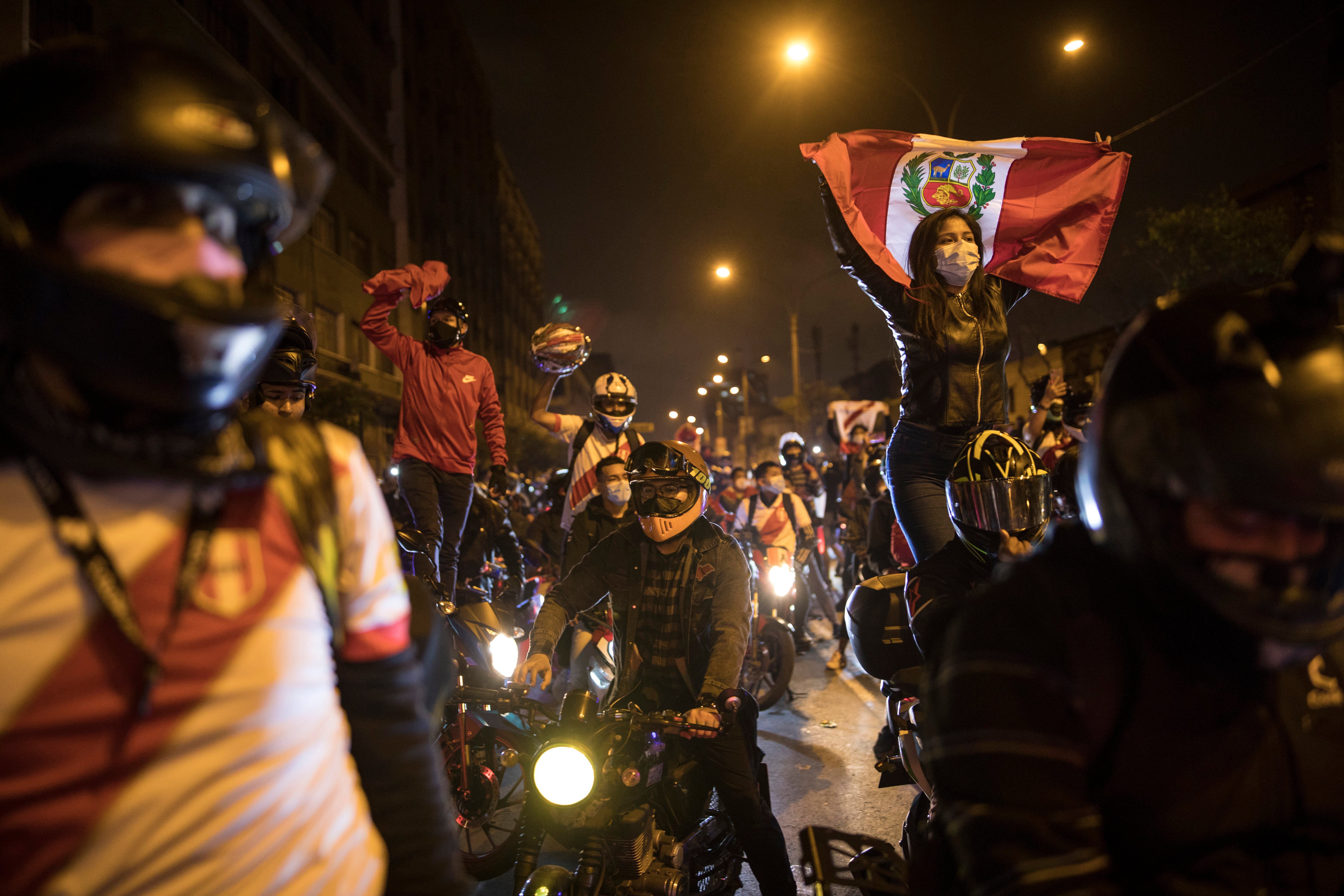 Demonstrators on motorcycles wait for news on who will be Peru’s next president, in Lima on Sunday