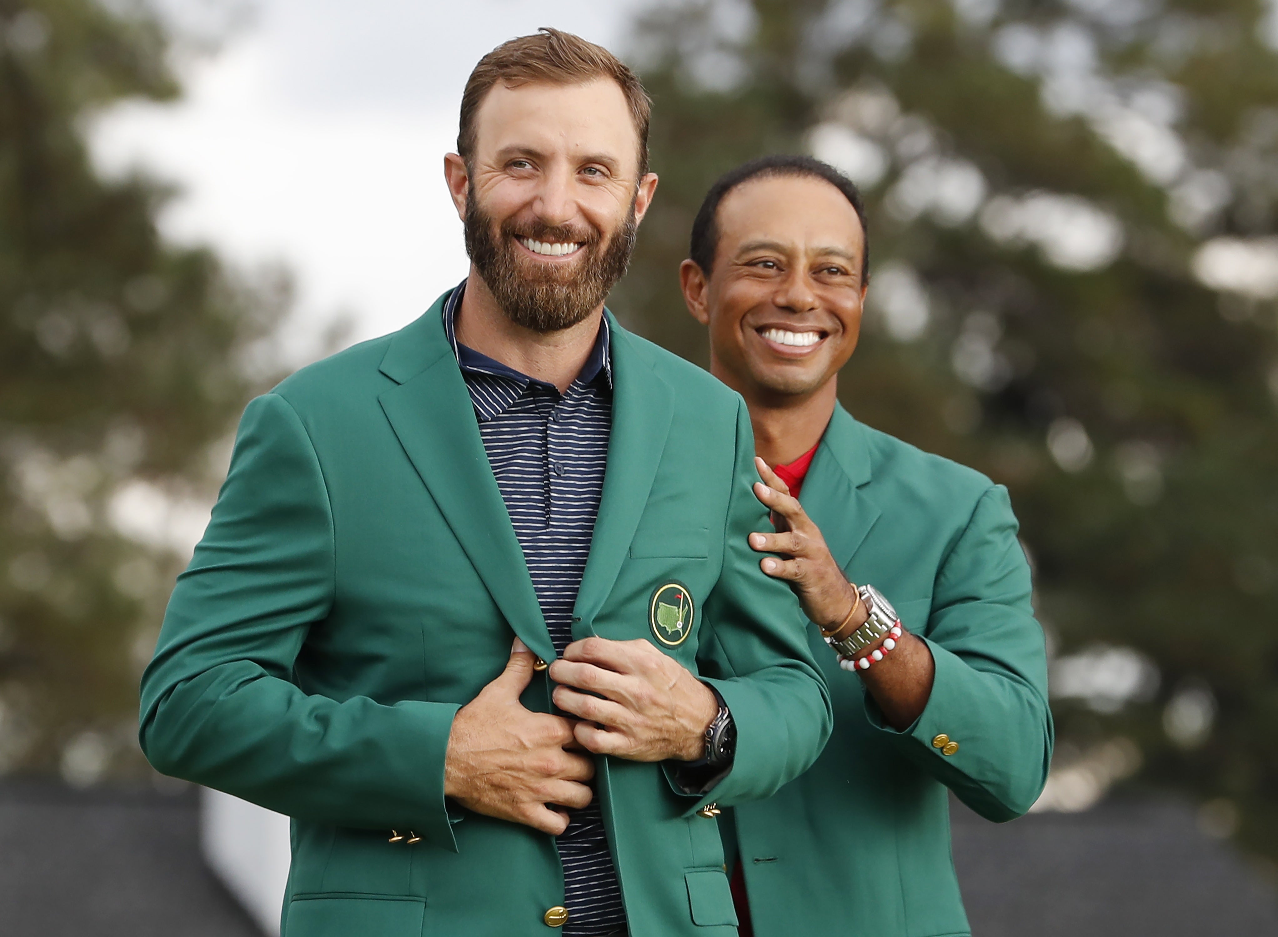 Dustin Johnson could barely believe his Masters victory as Tiger Woods presented him with the Green Jacket