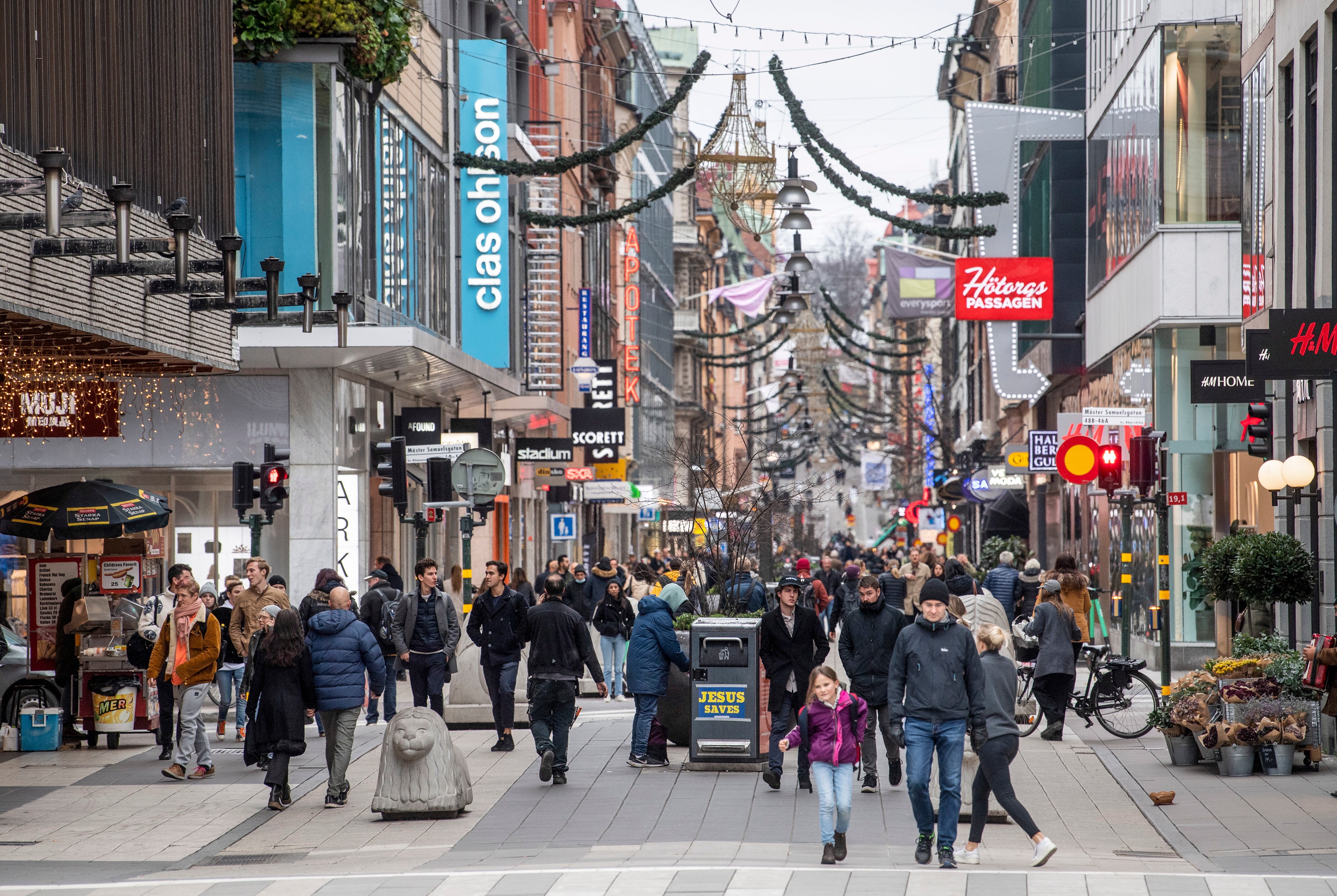 People stroll at the Drottninggatan shopping street in central Stockholm, Sweden