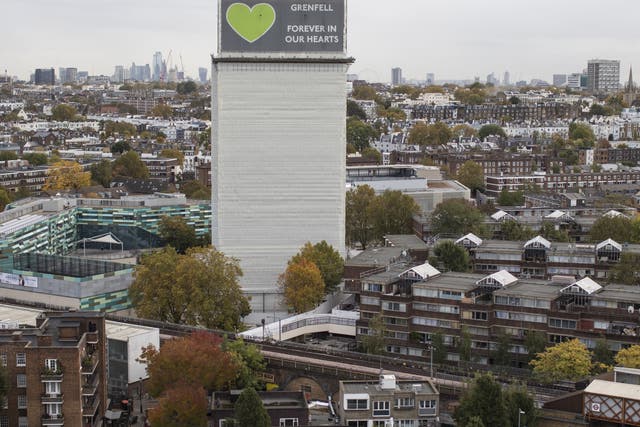 A general view of what remains of Grenfell Tower covered with hoardings in October 2019