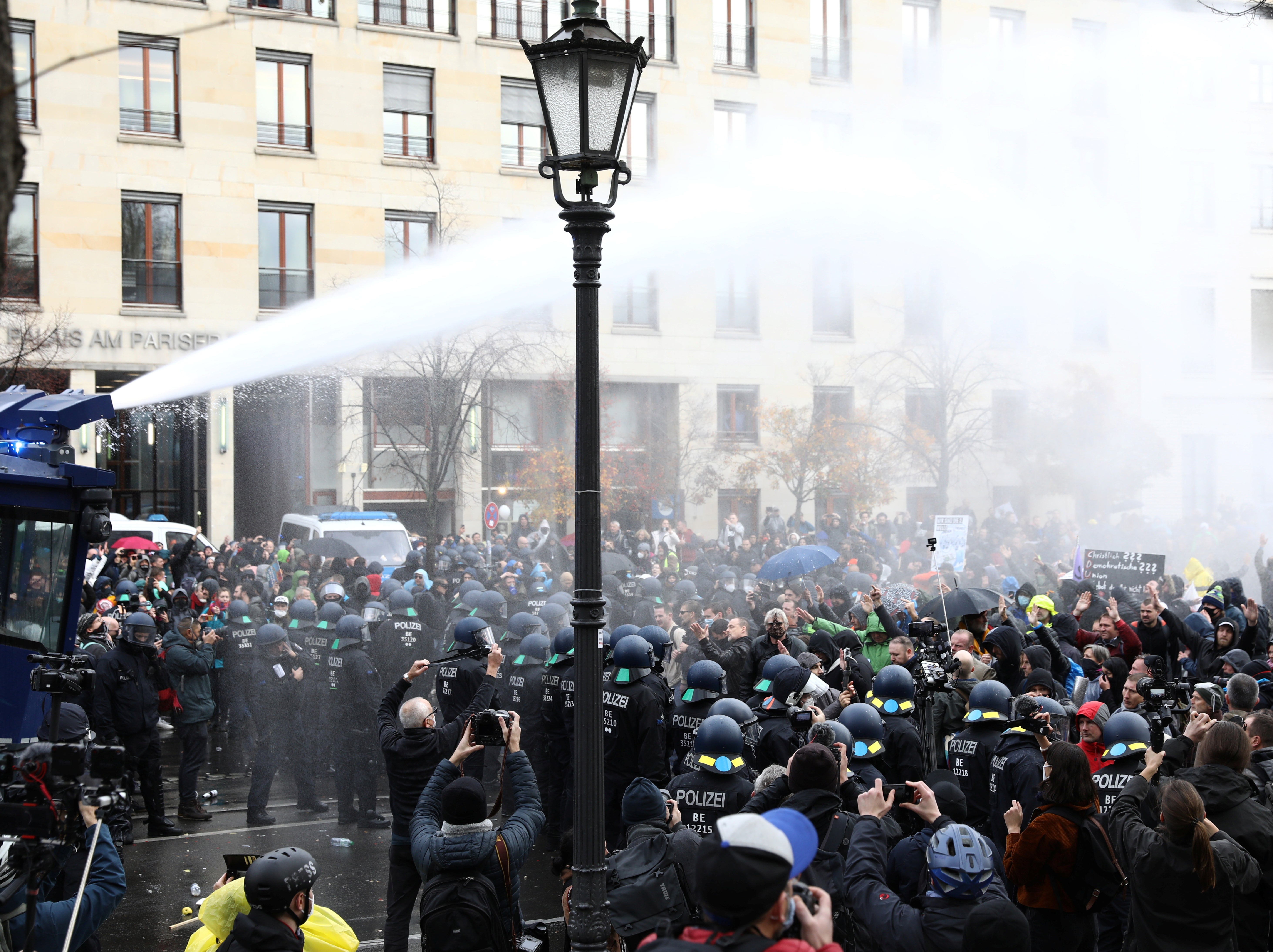 Police use water cannon during a protest against the government’s coronavirus restrictions