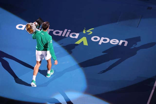 Novak Djokovic holds the trophy after winning the Australian Open 2020