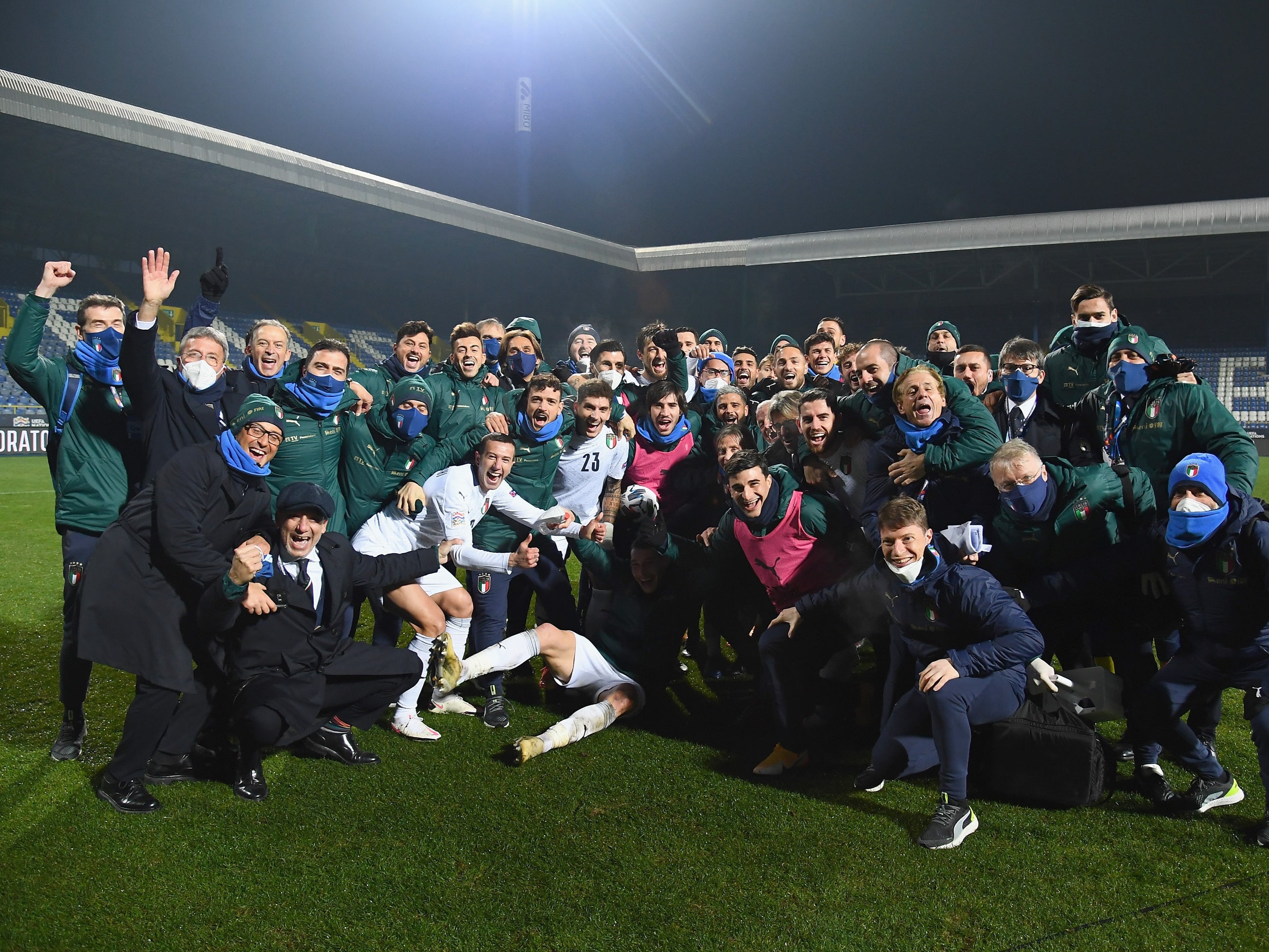 Italy players and staff celebrate after their victory