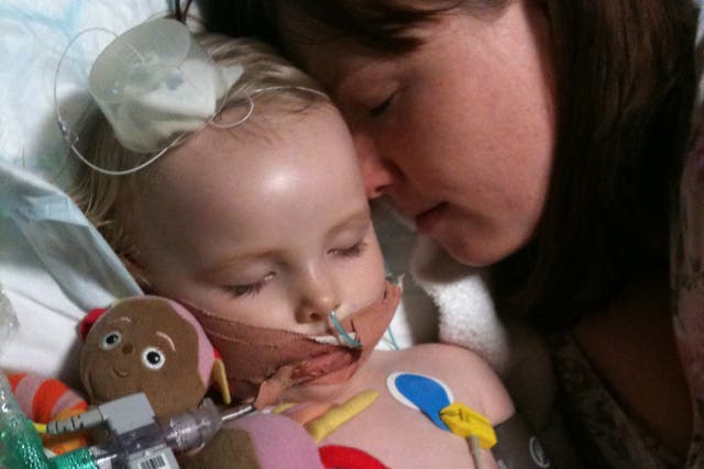 <p>Jo Hughes with her daughter Jasmine in intensive care at Great Ormond Street</p>