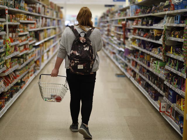 A shopper browses an aisle for groceries at a Tesco Superstore in south London on September 30, 2019. The Co-op says its own shop workers have seen a rise in abuse from customers since last year.