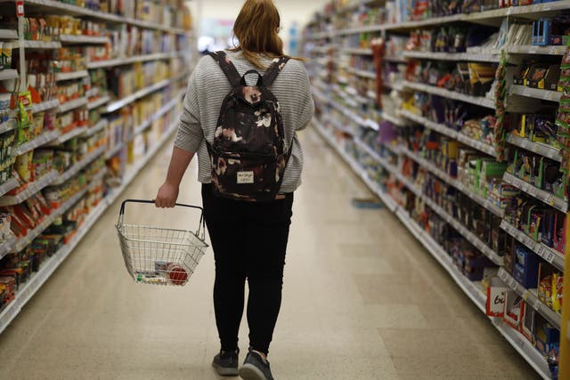 A shopper browses an aisle for groceries at a Tesco Superstore in south London on September 30, 2019. The Co-op says its own shop workers have seen a rise in abuse from customers since last year.