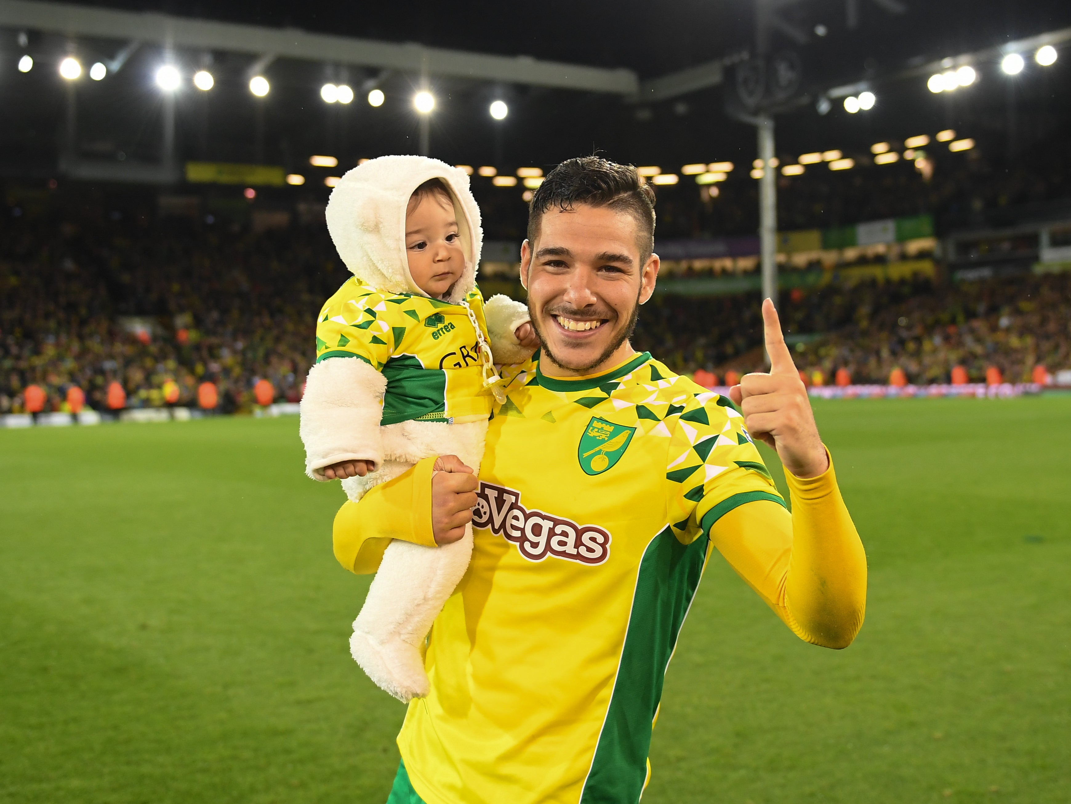Emiliano Buendia celebrates with his son, Thiago, after Norwich secure promotion in 2019
