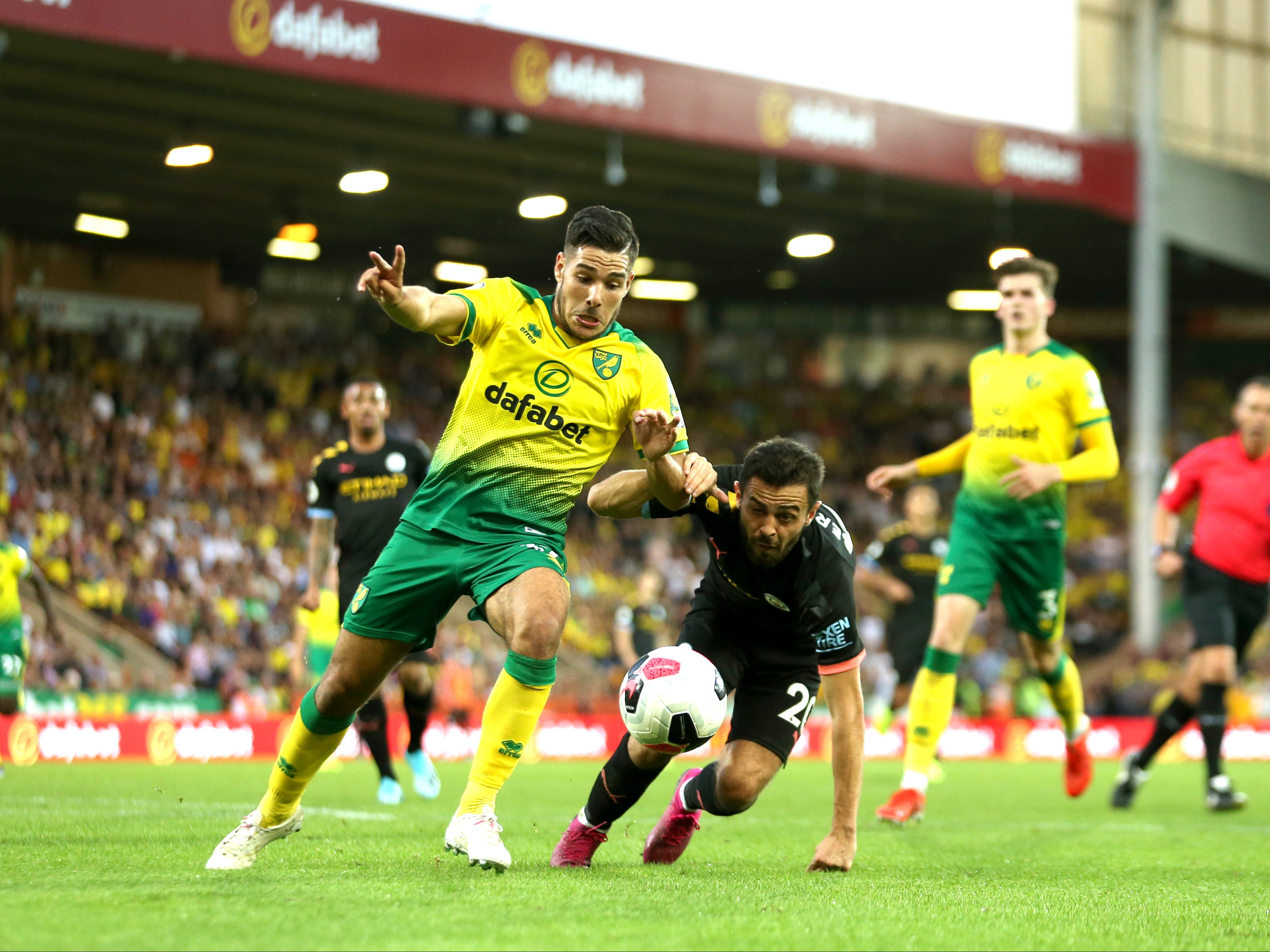 Emiliano Buendia dribbles past Bernardo Silva as Norwich defeat Man City