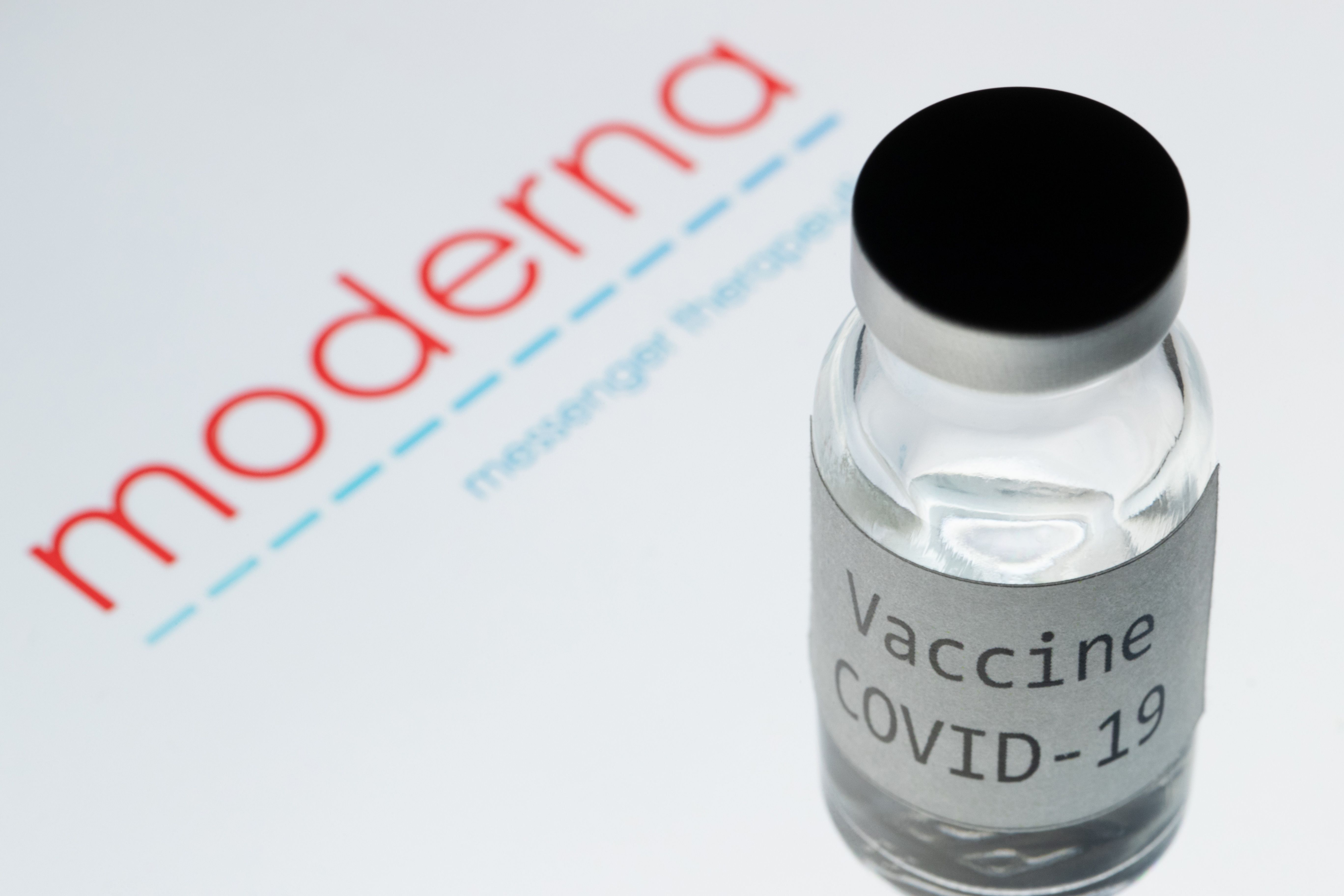 A photo shows a bottle reading “Vaccine Covid-19” next to a logo of the Moderna biotech company, which is developing a coronavirus vaccine.