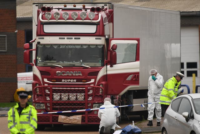 <p>Police and forensic officers examine the lorry at Waterglade Industrial Park in Grays, Essex</p>