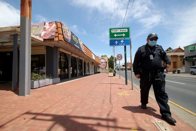 <p>Police outside the Woodville Pizza Bar after it was announced that a worker from the shop ‘lied’ to authorities during a Covid investigation</p>