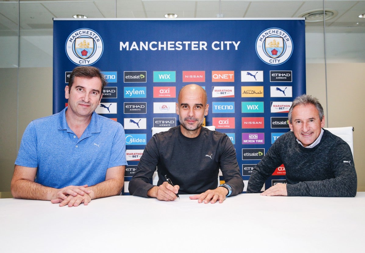 Manchester City manager Pep Guardiola signs a new contract