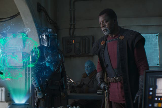 The Mandalorian inspects a holographic map in ‘Chapter 12: The Siege'