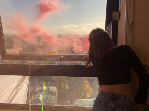 Students let off flares after occupying Manchester University’s Owens Park Tower