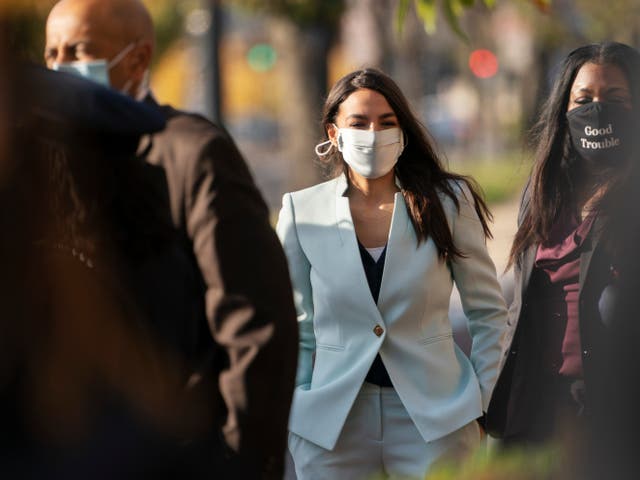 Rep Alexandria Ocasio-Cortez, center, arrives for an event with Rep.-elect Cori Bush, right on Thursday, 19 November 2020, outside the Democratic National Committee