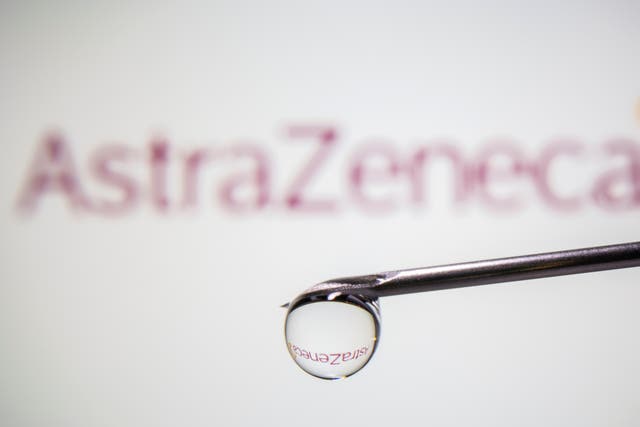 AstraZeneca's logo is reflected in a drop on a syringe needle in this illustration
