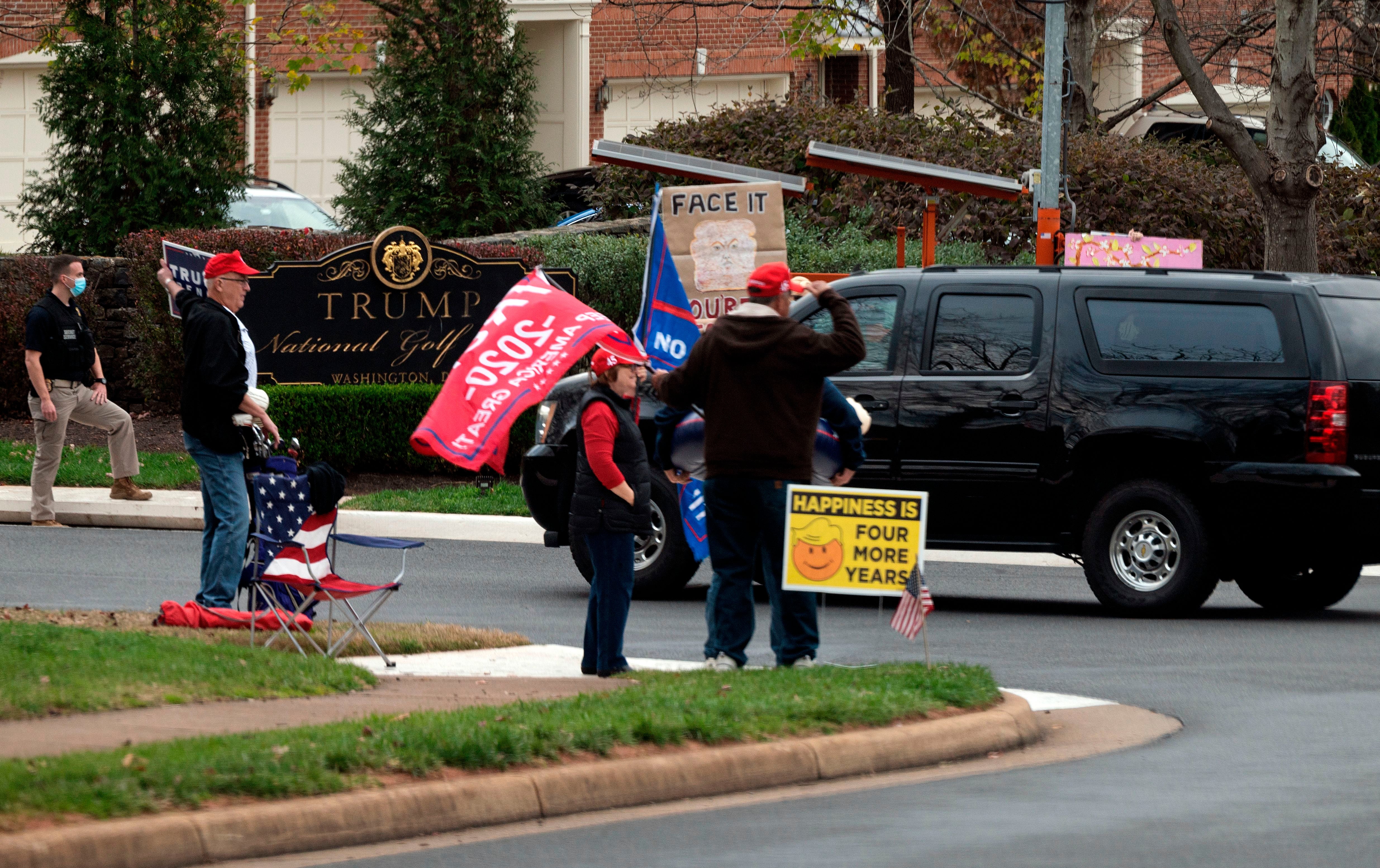 Supporters cheer as President Trump’s motorcade entered the Trump International Golf Club in Sterling, Virginia