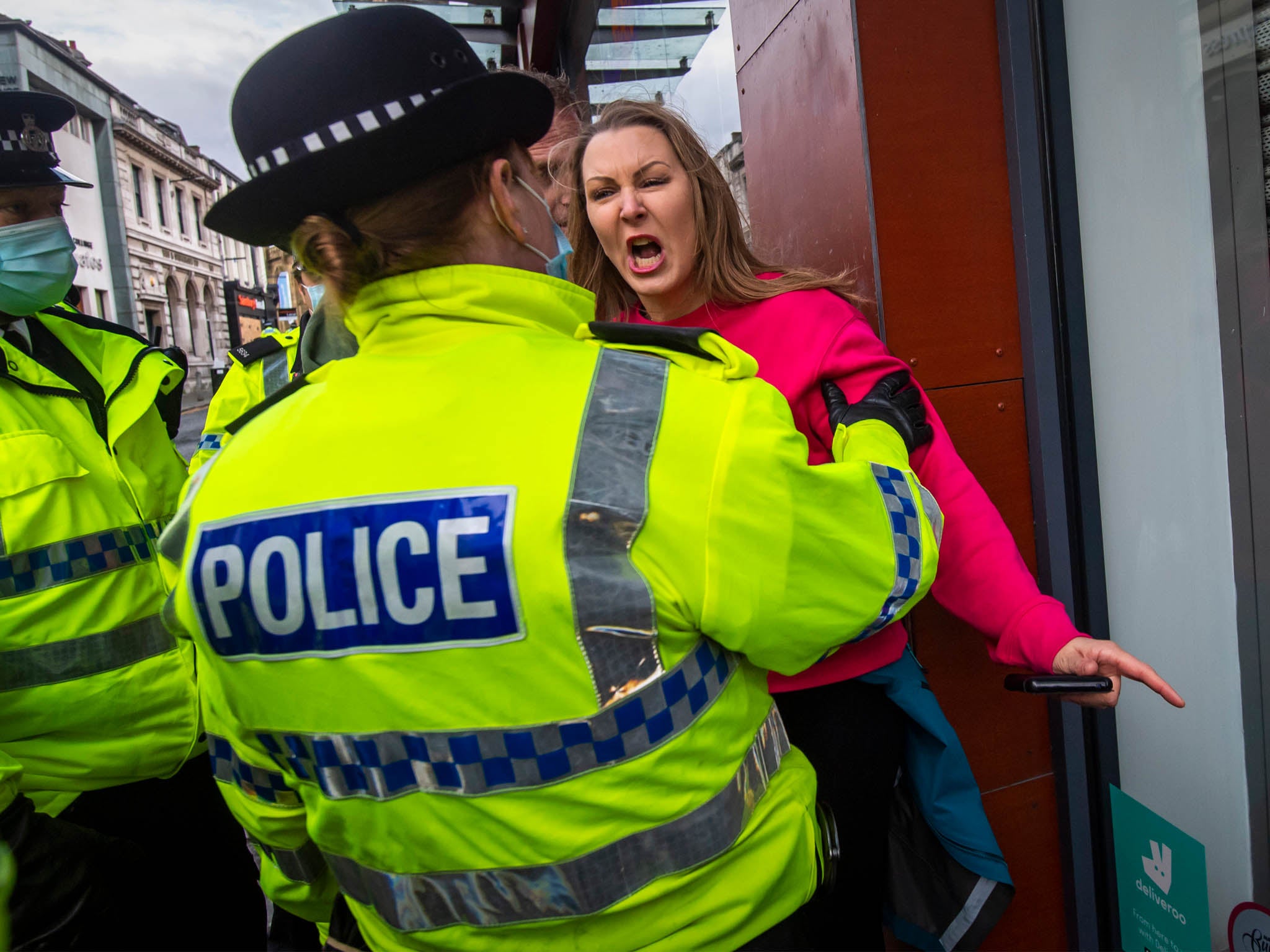 <p>A woman clasheswith police at an anti-lockdown march in Liverpool on 14 November</p>