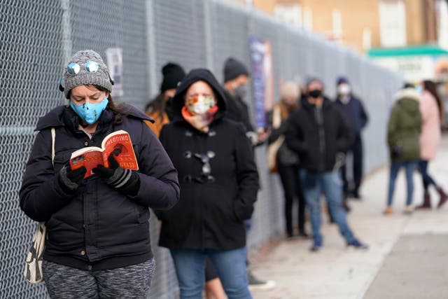 People wait in line outside a New York City Health + Hospitals COVID testing site in the Brooklyn borough of New York, Thursday, Nov. 19, 2020.