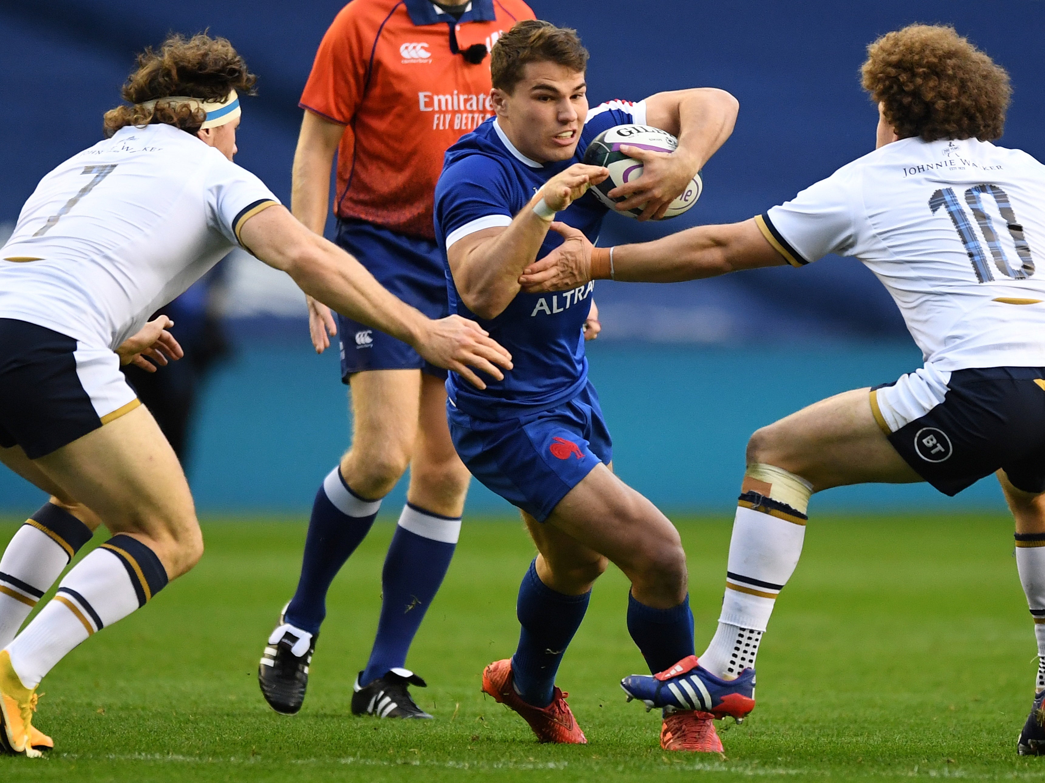 Antoine Dupont attempts to skip away from Scotland’s defence