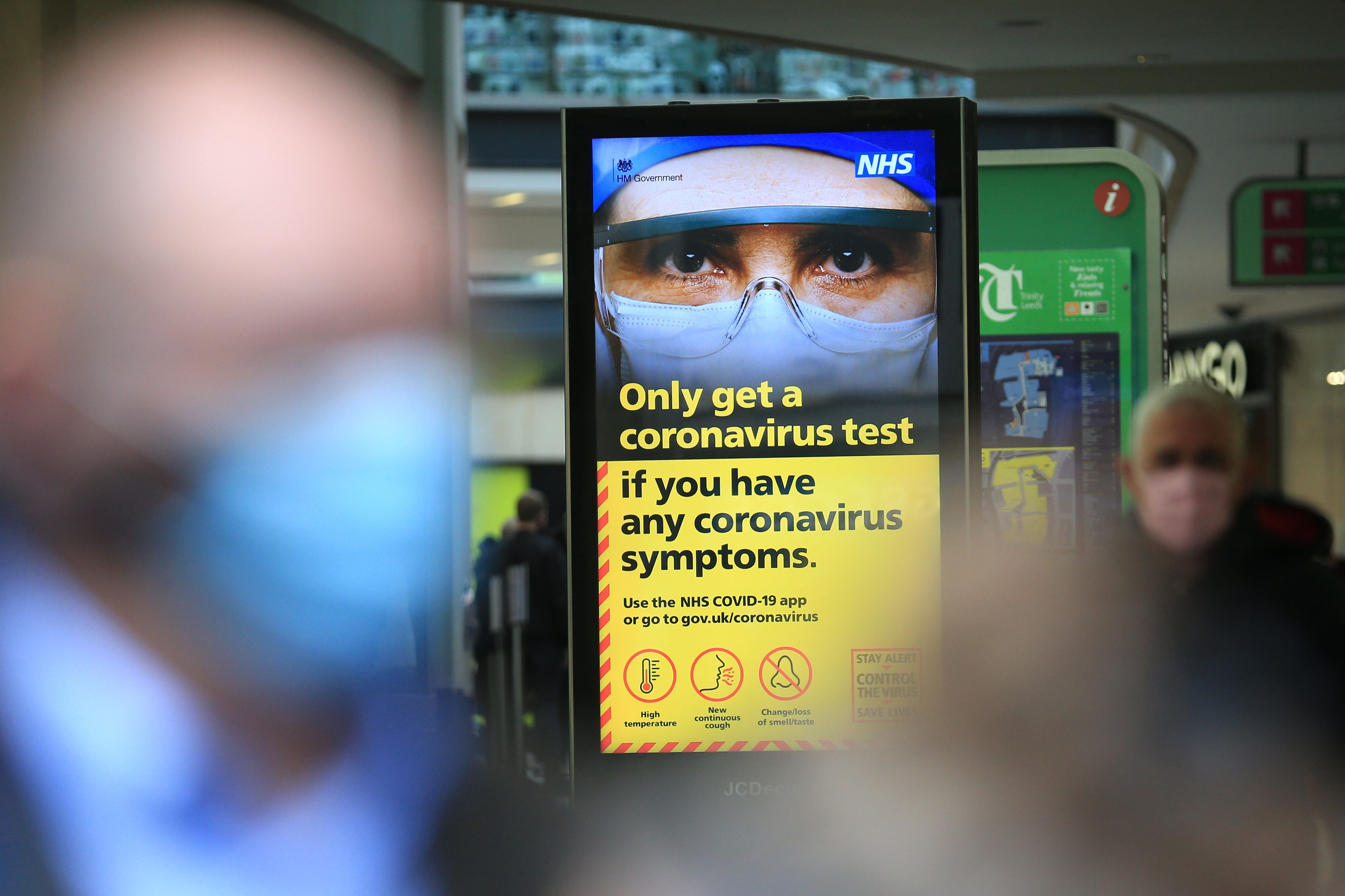A digital display shows NHS health advice on the coronavirus