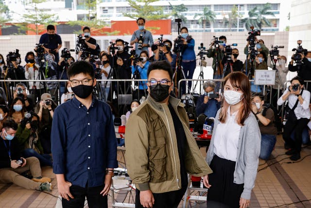 <p>Pro-democracy activists Ivan Lam, Joshua Wong and Agnes Chow arrive at the West Kowloon Magistrates’ Courts on Monday (23 November)</p>