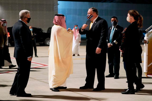 <p>Faisal bin Farhan (centre left) greets Mike Pompeo in Neom on Sunday</p>