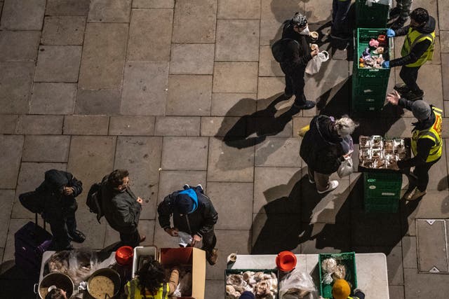 Homeless people collect donated food provided by charity, Rhythms of life near Trafalgar Square, London