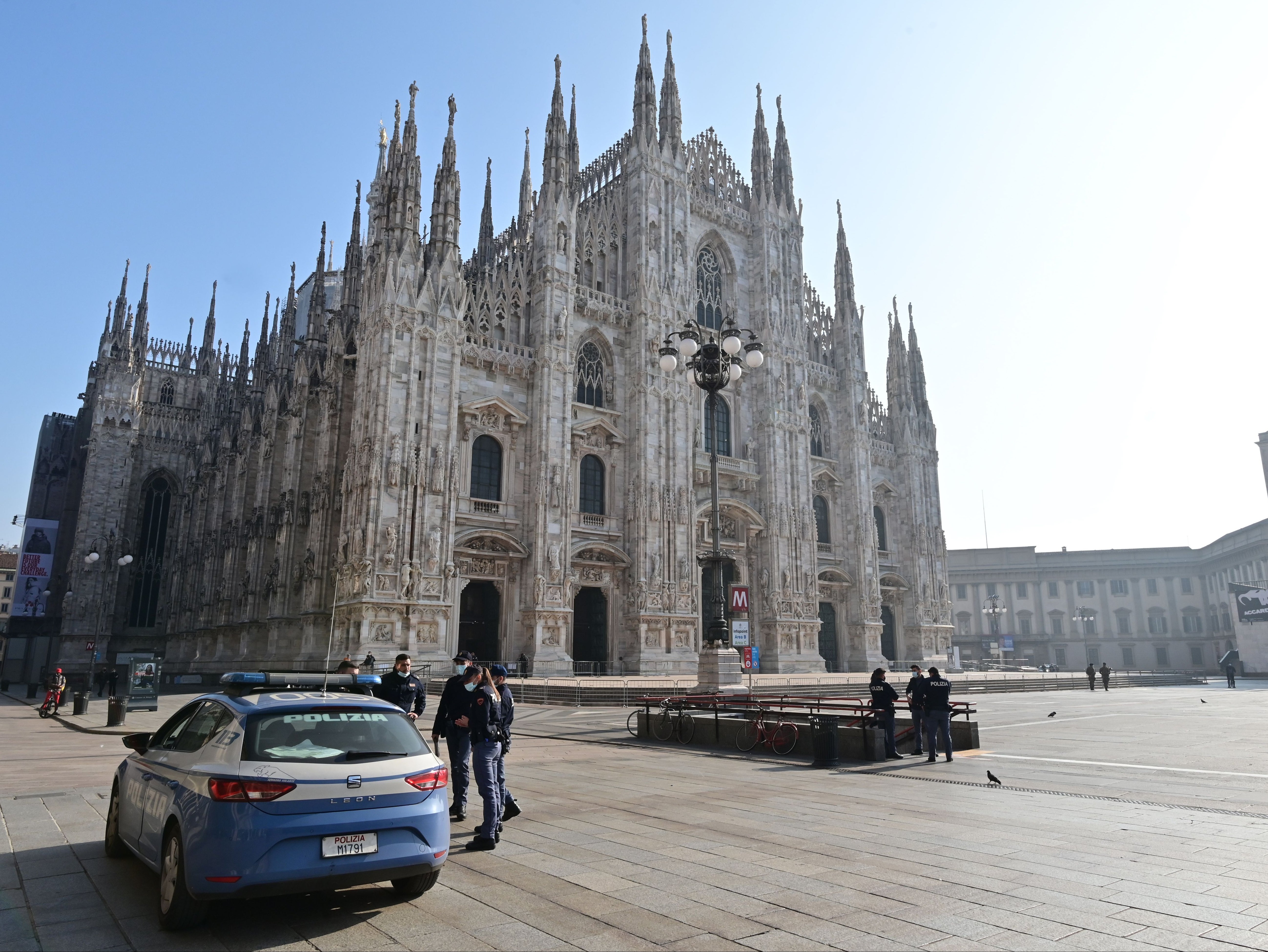 Police officers patrol in front of Milan’s Duomo amid local lockdown measures