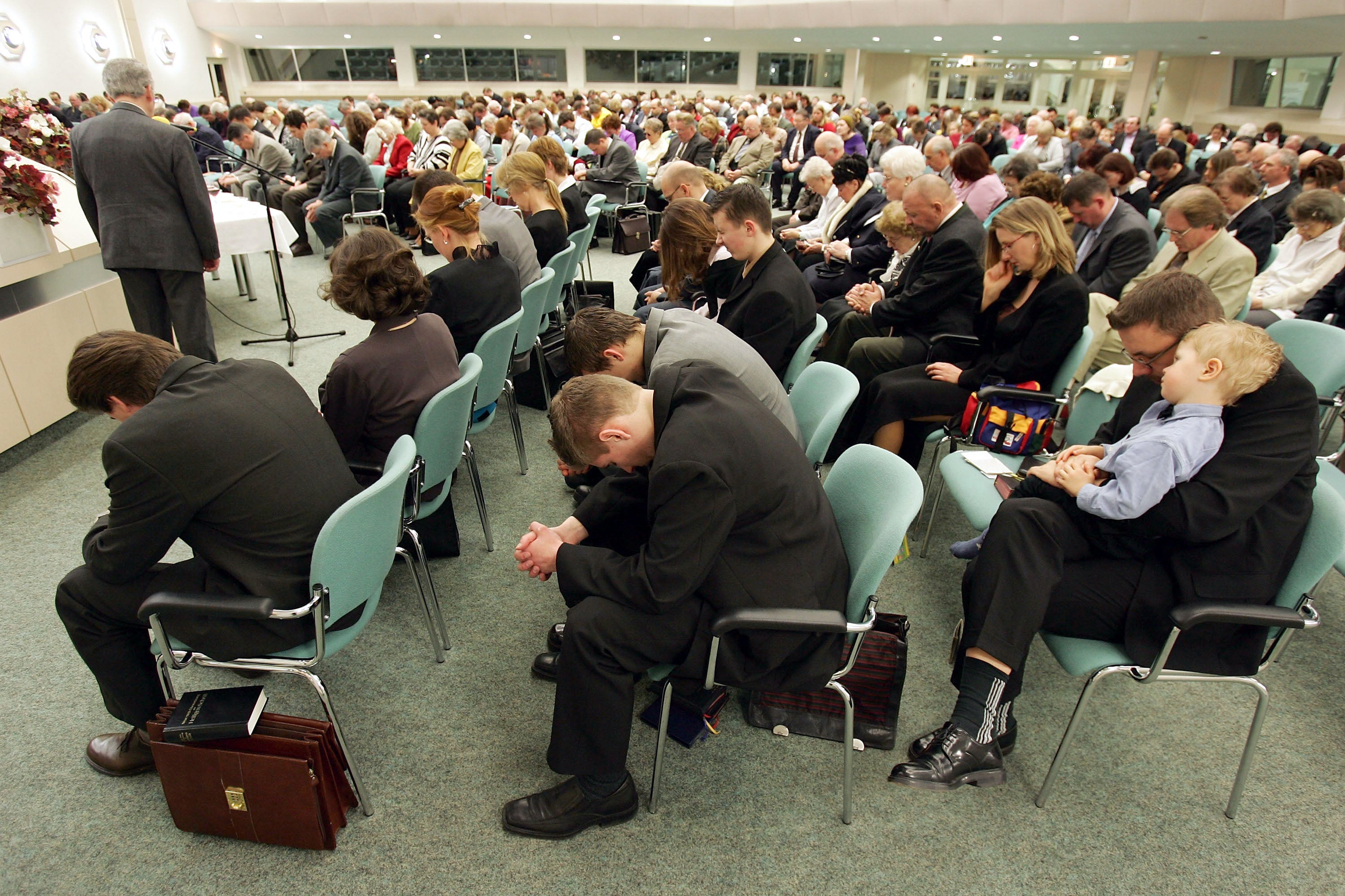 Members of the Jehova's Witnesses Church pray during a religious service