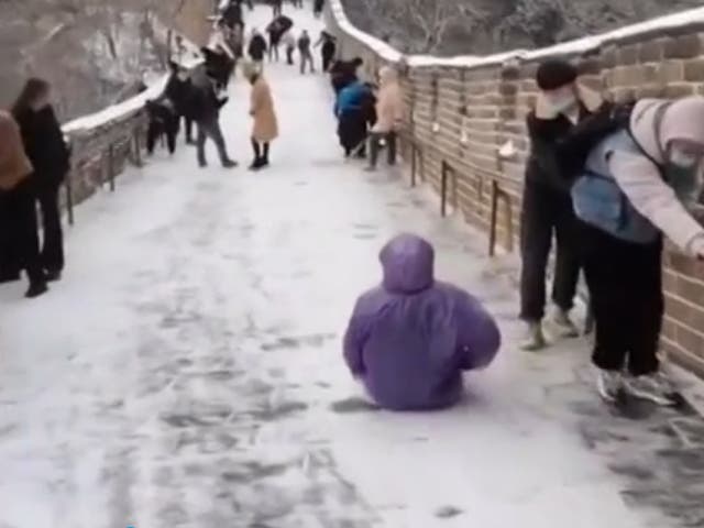 Tourist uses Great Wall as a slide