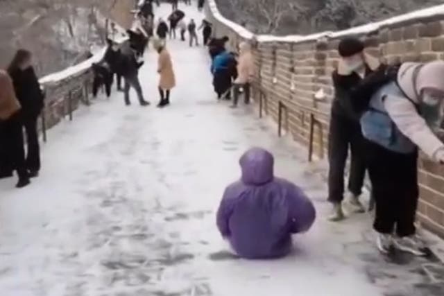 Tourist uses Great Wall as a slide