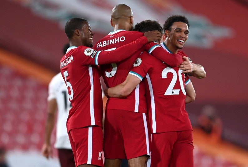 Liverpool players celebrate scoring a goal