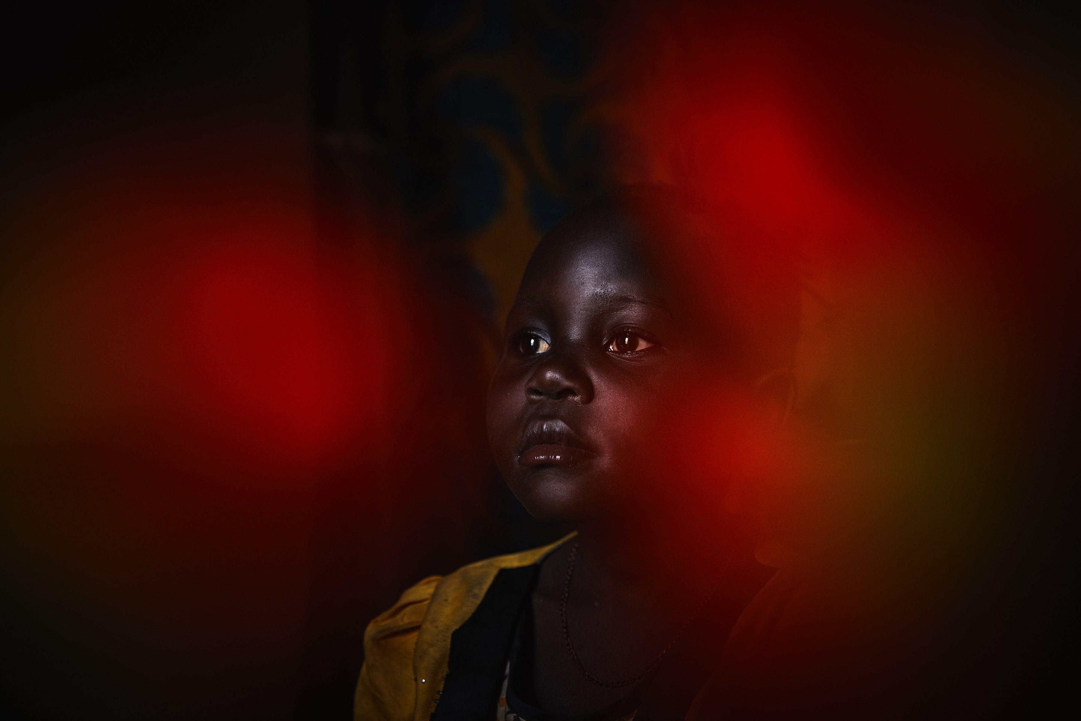 A portrait of Prisca*, six, inside her home in the Democratic Republic of Congo